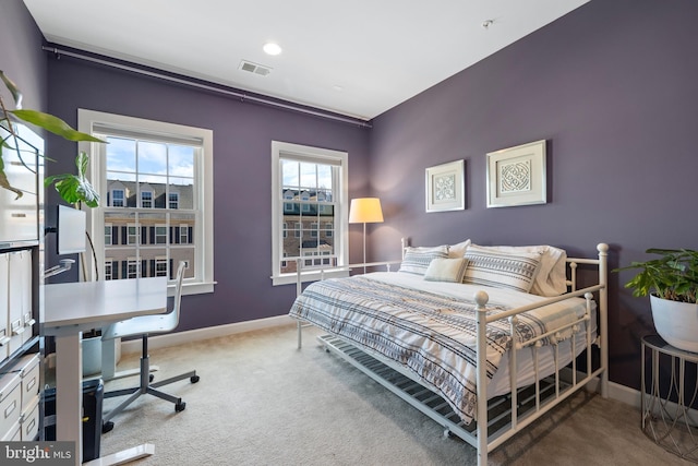 bedroom with carpet flooring, visible vents, and baseboards