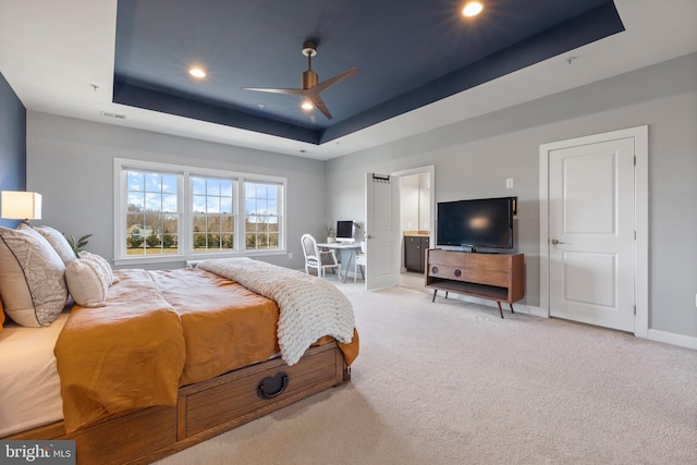 bedroom featuring light carpet, baseboards, visible vents, a tray ceiling, and recessed lighting