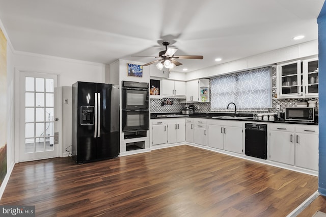 kitchen featuring sink, tasteful backsplash, black appliances, dark hardwood / wood-style floors, and white cabinets