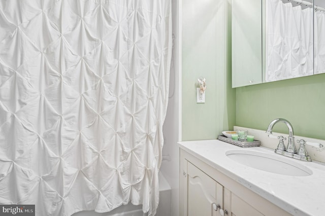 bathroom with shower / tub combo with curtain and vanity