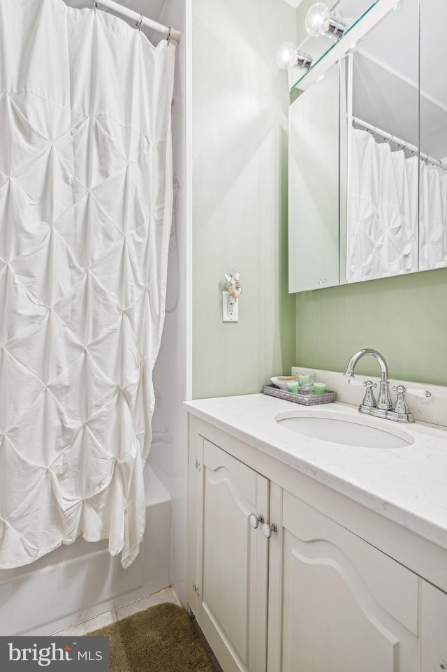 bathroom featuring tile patterned floors, shower / bath combo, and vanity