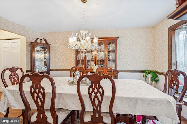 dining room featuring hardwood / wood-style flooring and a chandelier