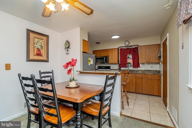 dining room featuring ceiling fan and light tile patterned floors