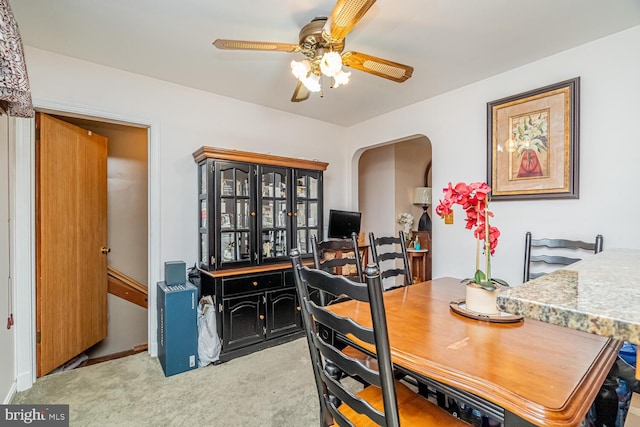 carpeted dining space featuring ceiling fan