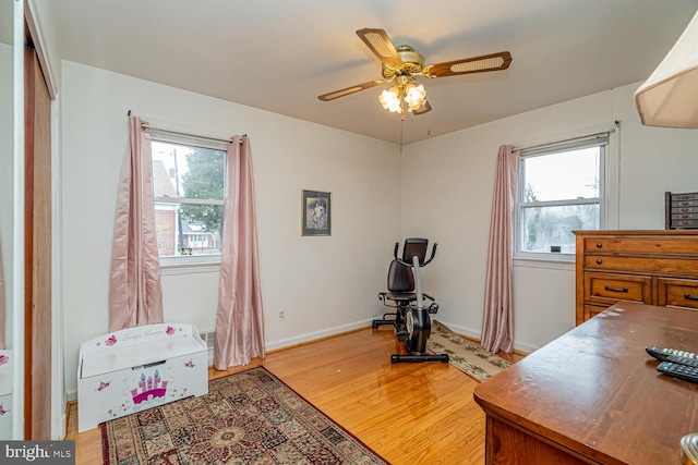 office with ceiling fan and light hardwood / wood-style floors