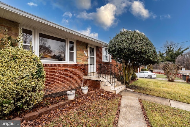 entrance to property with a lawn