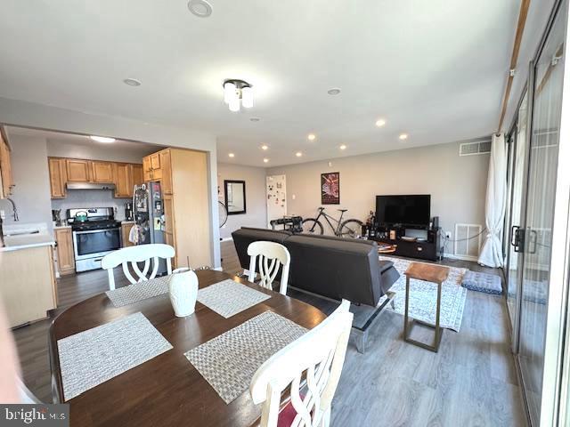 dining area featuring hardwood / wood-style flooring and sink