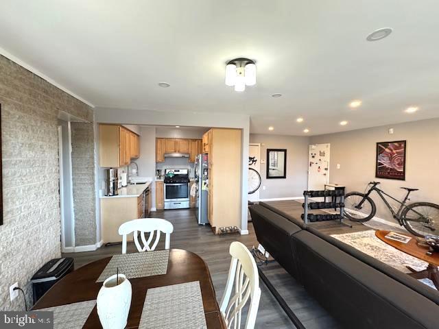 dining area featuring sink and dark hardwood / wood-style flooring