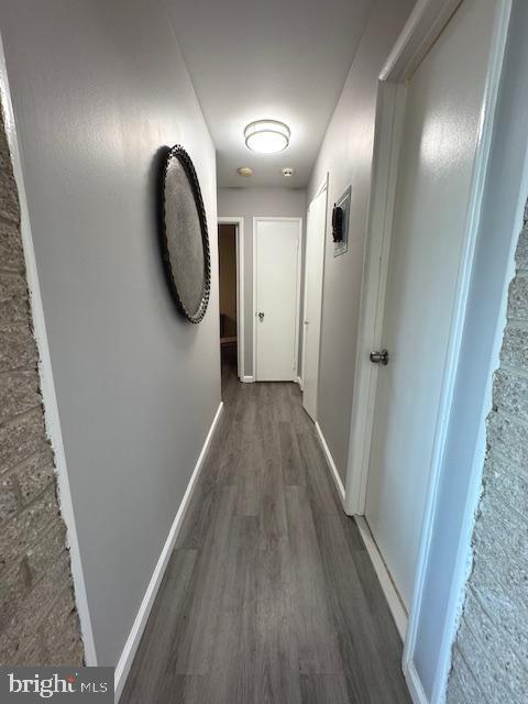 hallway with dark wood-type flooring