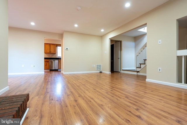 unfurnished living room featuring light hardwood / wood-style flooring