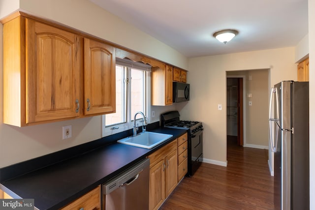 kitchen with sink, dark hardwood / wood-style floors, and black appliances