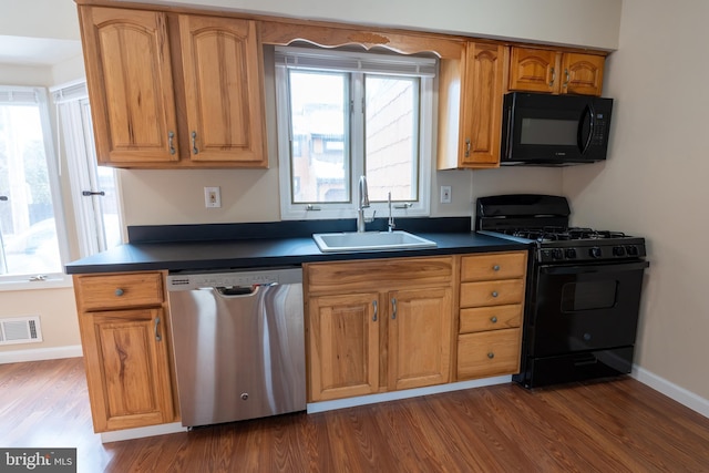 kitchen with dark hardwood / wood-style flooring, sink, and black appliances