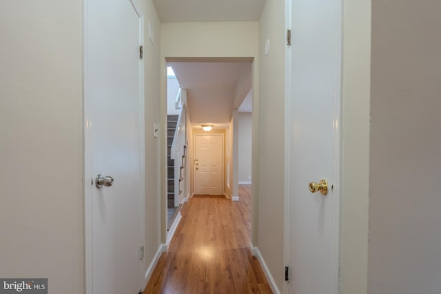 hallway with light hardwood / wood-style flooring