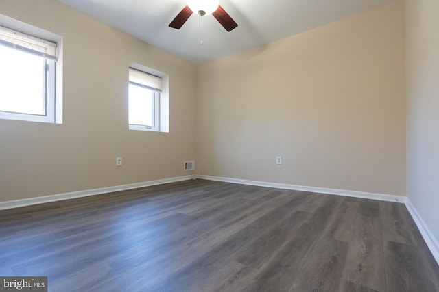 spare room featuring ceiling fan and dark hardwood / wood-style floors