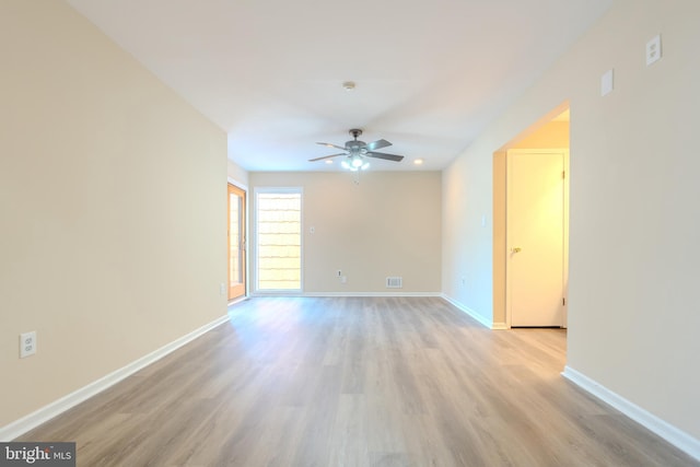 empty room featuring ceiling fan and light hardwood / wood-style floors