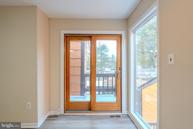 doorway with hardwood / wood-style floors