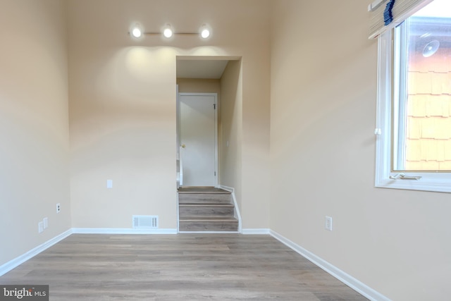 stairway with hardwood / wood-style flooring