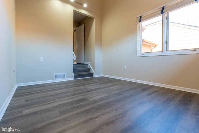 unfurnished living room with dark wood-type flooring