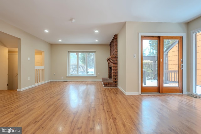 unfurnished living room featuring a fireplace and light wood-type flooring