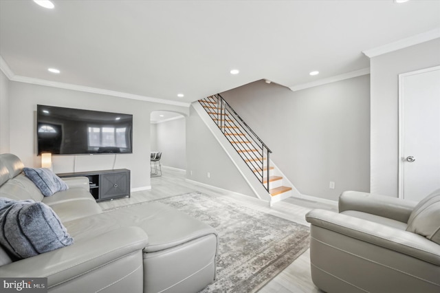 living room with crown molding and light hardwood / wood-style floors