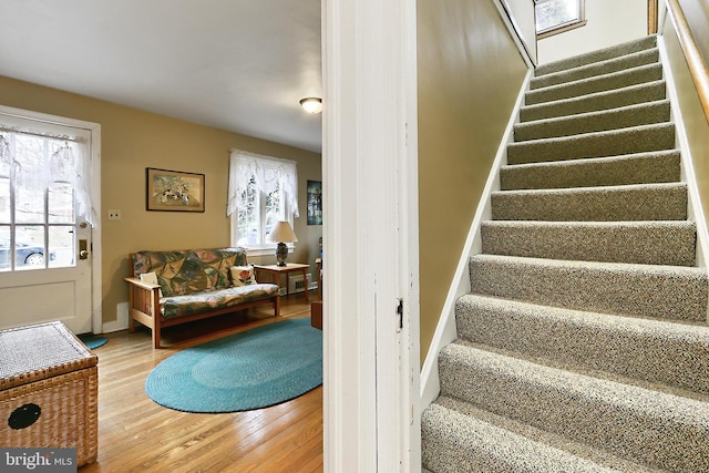 stairs with baseboards and wood finished floors