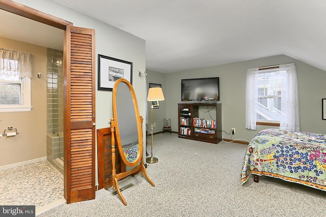 bedroom with lofted ceiling, multiple windows, carpet, and baseboards