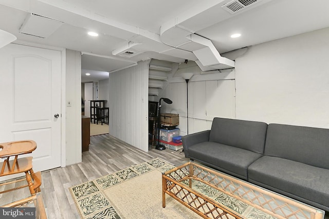 living room with recessed lighting, visible vents, and light wood-type flooring