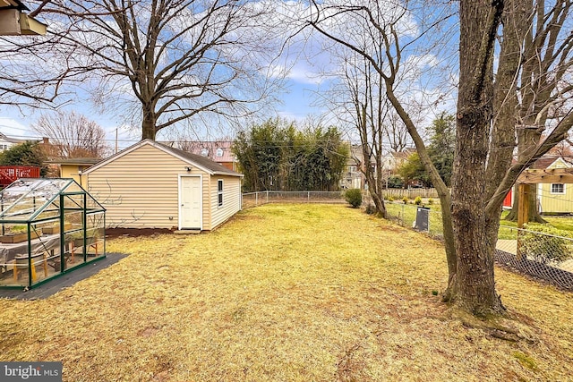 view of yard featuring an exterior structure, an outbuilding, and a fenced backyard