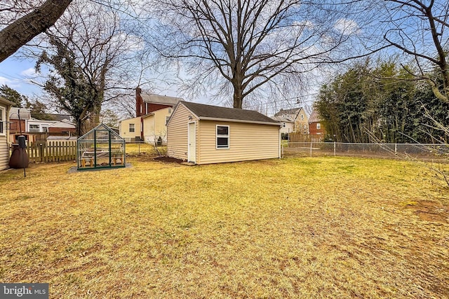 view of yard with an outbuilding and a fenced backyard