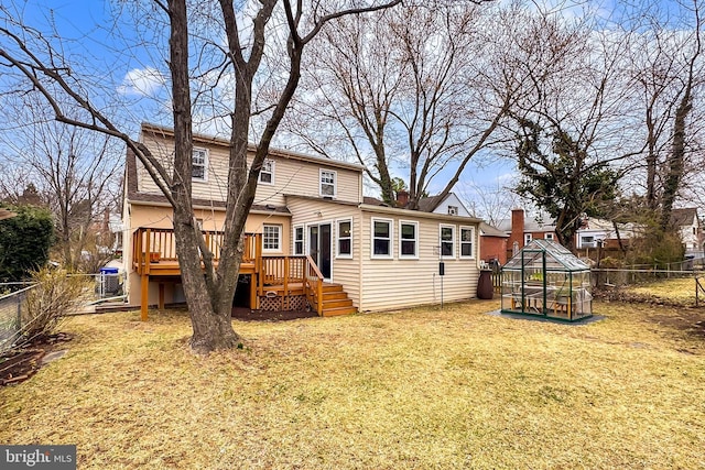 back of house featuring a yard, a wooden deck, and a fenced backyard