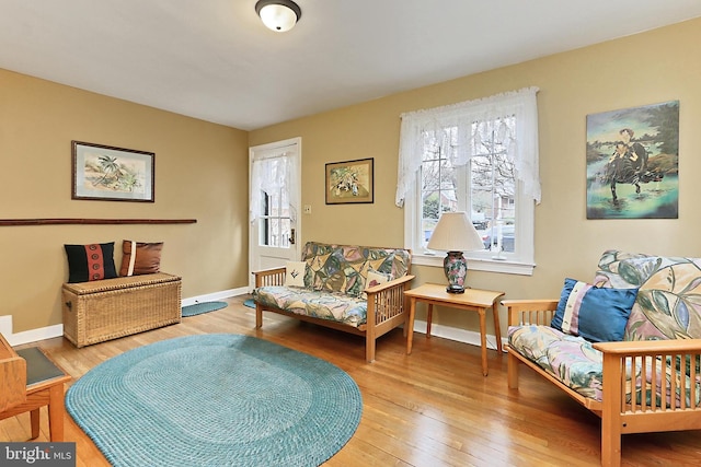 sitting room with baseboards and hardwood / wood-style floors