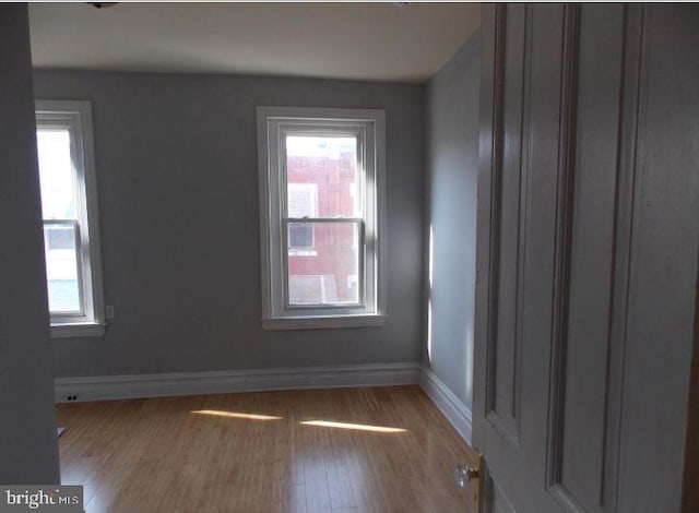 unfurnished room with light wood-type flooring