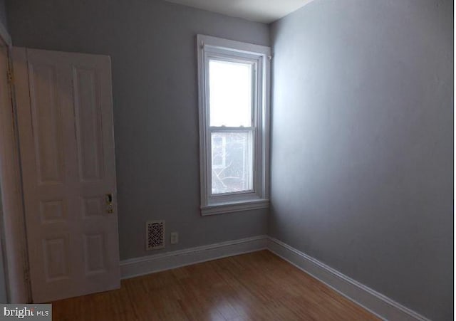 unfurnished room featuring hardwood / wood-style floors