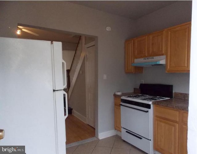 kitchen featuring white appliances and light tile patterned floors