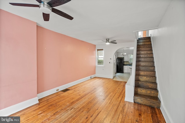 interior space with a notable chandelier and light hardwood / wood-style flooring