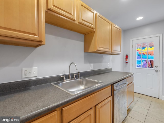 kitchen featuring dishwasher, sink, and light tile patterned flooring