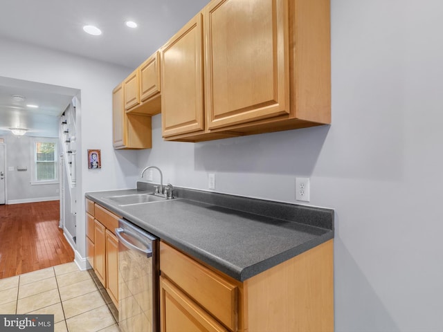 kitchen with sink, light tile patterned floors, and stainless steel dishwasher