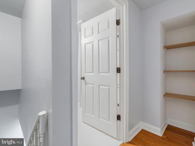 hallway with hardwood / wood-style floors