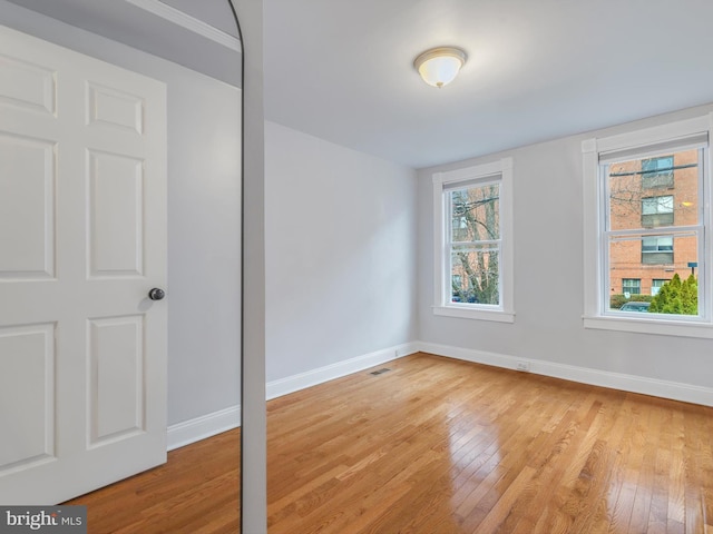 unfurnished room with a healthy amount of sunlight and light wood-type flooring