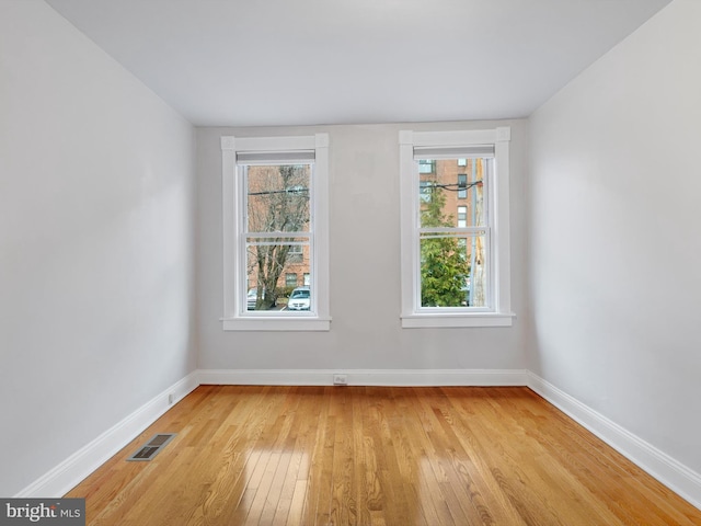 spare room with light hardwood / wood-style flooring