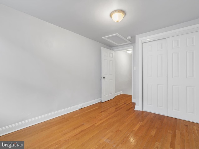 unfurnished bedroom with light hardwood / wood-style floors and a closet