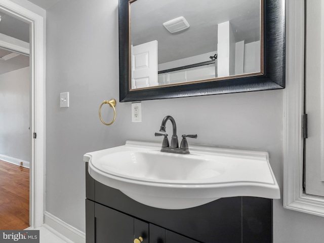 bathroom with vanity and hardwood / wood-style floors