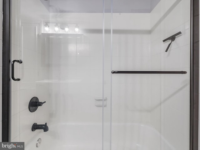 bathroom with shower / bath combination with glass door