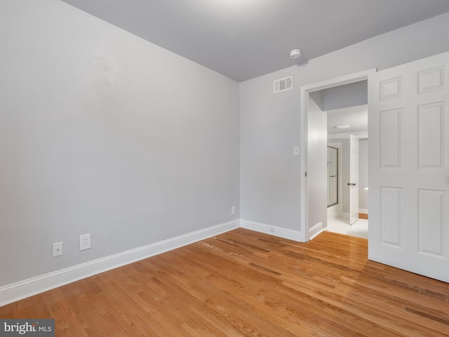 empty room with light hardwood / wood-style floors