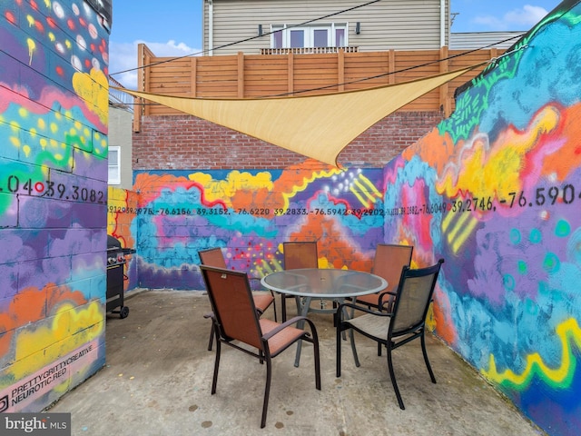 patio terrace at dusk with a grill