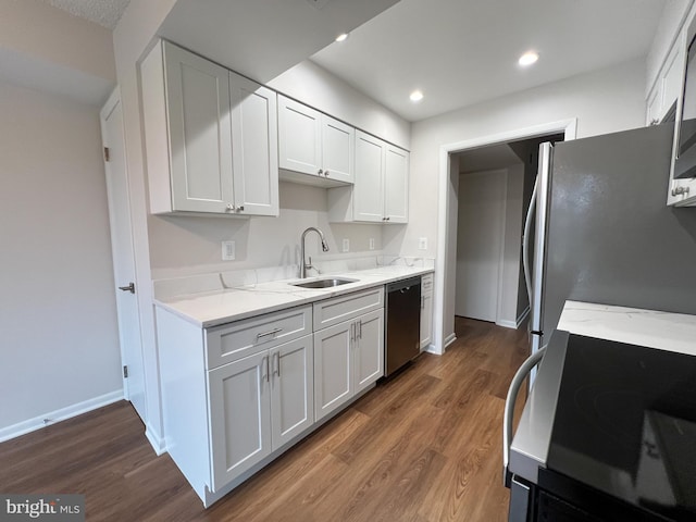 kitchen with dark wood-type flooring, appliances with stainless steel finishes, sink, and white cabinets