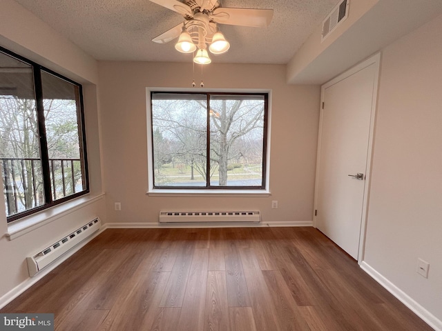 unfurnished dining area featuring hardwood / wood-style floors, a baseboard radiator, a textured ceiling, and ceiling fan