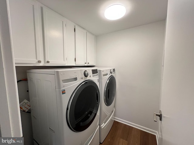 laundry room with cabinets, dark hardwood / wood-style floors, and independent washer and dryer