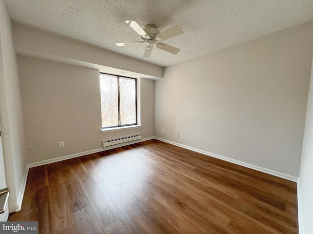 empty room with a baseboard heating unit, hardwood / wood-style floors, a textured ceiling, and ceiling fan