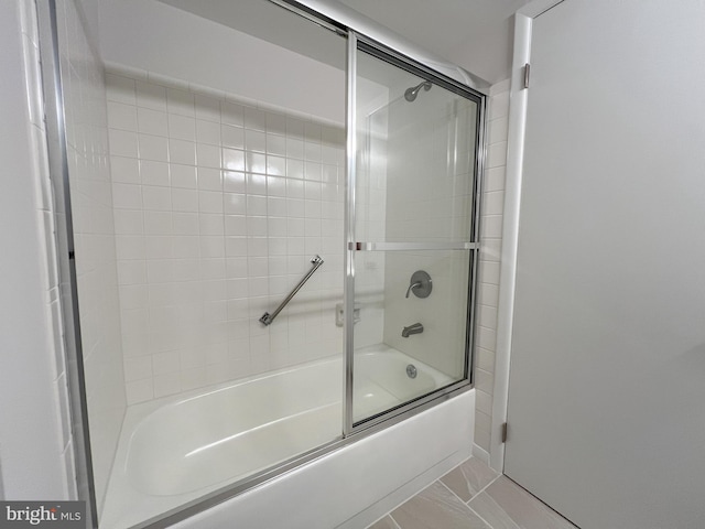 bathroom featuring shower / bath combination with glass door